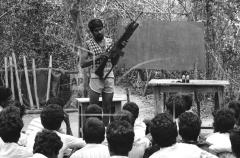 An instructor demonstrated the use of an M-16 automatic rifle and a M-90 grenade launcher to a class of recruits during a weapons training session, June 7, 1985 near Paranthan,.jpg