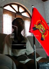 Fifteen-year-old Senthilnathan Arulraj speaks to the media next to a flag of the Tamil Tigers, at Kokkadichcholai, a rebel-held region of Batticaloa, about 220 kilometers (138 miles) northeast of Colombo, Sri Lanka, Frida.jpg