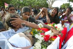 Relatives of Tamil Tiger fighter Sangeethan mourn during his funeral ceremony in Kilinochchi..jpg