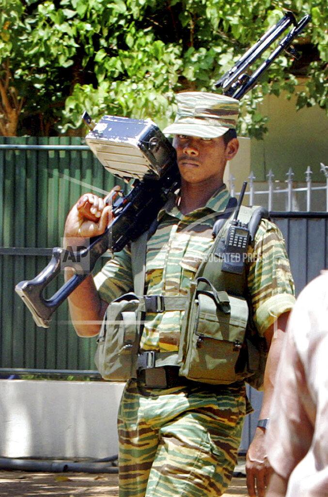 A Tamil Tiger rebel stands guard during the meeting of S.P. Thamilselvan and Norway ambassador to Sri Lanka Hans Brasttar in Kilinochchi, in northern Sri Lanka, in this Wednesday, June 21 2006.jpg