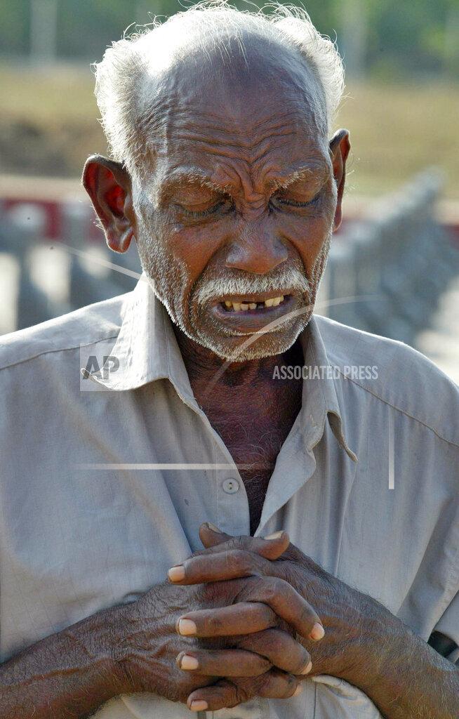 Father of female Tamil rebel fighter Siyamala Nadesu alias Major Kayalveli, mourns in front of her grave at a graveyard for Liberation Tigers of Tamil Eelam (LTTE) rebels in Kilinochchi, april 20, 2007.jpg