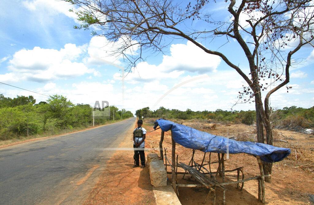 A young female Tamil Tiger fighter stands guard on the main A9 highway close to Kilinochchi, July 11, 2007..jpg