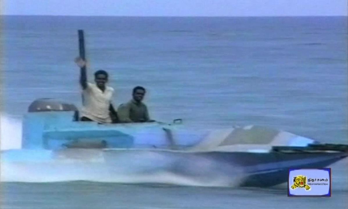 LTTE Sea Black Tiger Major Mayuran with another Sea Black Tiger riding a Idiyan Class Boat.jpg