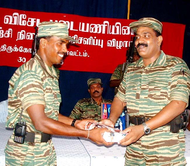 LTTE's Special Commander for Trincomalee Col. Sornam (right) hands over special prize to Mr.Kilman, training instructor.jpg