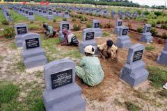 Locals tend to graves of LTTE fighters in Kopay Cemetery, Jaffna in preparation of Maaveerar Naal (Hero's Day) - 2003.  (3).jpg