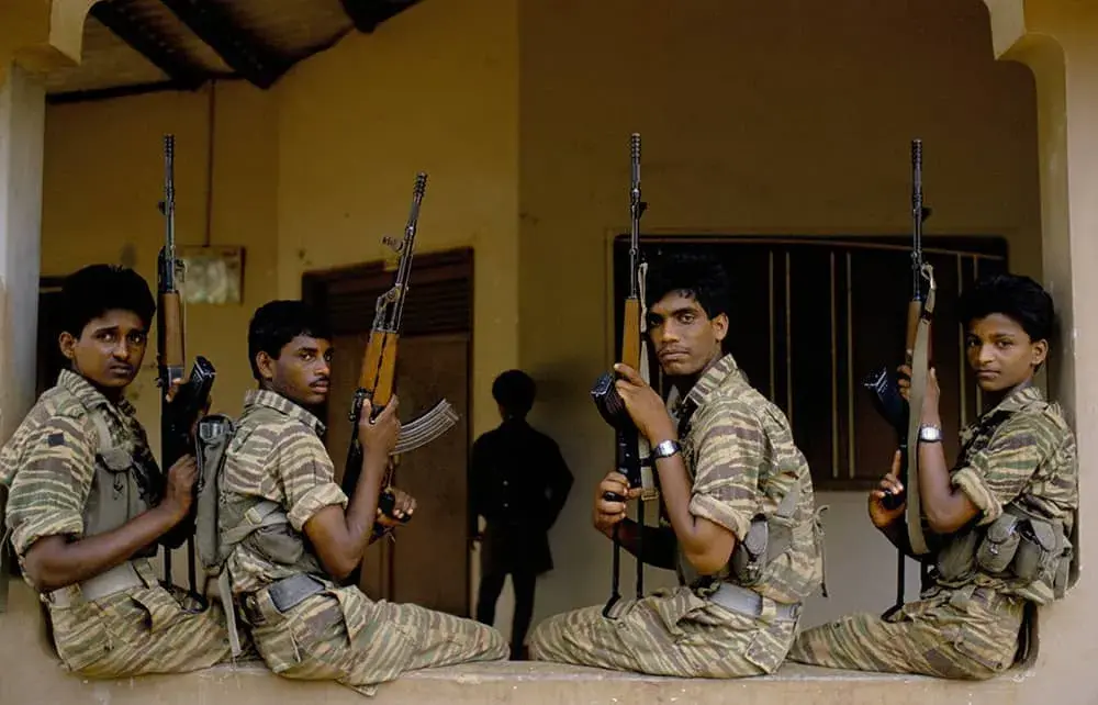 Tamil Tigers sitting on a wall in their base at at Jaffna, 1991
