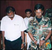 Mr. Karikalan and Maj. Gen. Sunil Tennekoon observing two minutes of silence before the conference to pay homage to the war dead in the northeast. - 03 July 2002.png