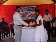 children_saving_24_03_06_04 Tamil Eelam Bank Director V. Cholamaravan issues saving account books to students..jpg
