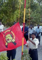 TEEDOR Trincomalee district head Mr.Tharman is seen hoisting the Thamileelam national flag - Nitharsanam film Amma Nalama released in Trincomalee - 10 april 2004.jpg