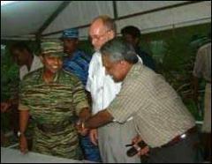 gosl_ltte_meeting_1_161102 Defence Ministry Secretary Austin Fernando and theepna, cheliyan, arivu, iniyavan, pulithevan, ilamparuthi shake hands while SLMM Jaffna representative looks on..jpg