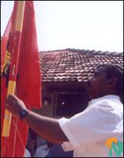 ltte-office_vavuniya_5_030202 Mr. Poovannan hoisting the Tamil Eelam flag at the LTTE's office in Vavuniya.jpg