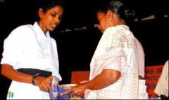 film_080303_3 Ms Kuyili is seen handing over the first copy of the film to Martyr Major Rajmohans' mother Film on Women's sacrifice to Tamil struggle released.jpg