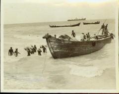 Dockers at Kankesanturai Port Wading Waist - Deep in Water Carrying Bags of Food Cargo on Their Heads from Cargo on Their Heads from Small Boats That had Transported Them from the Ocean Going Cargo Freighters 1980-711.jpg