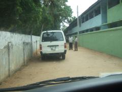 Outside the TMVP office in Tirukkovil - White van with newspaper in place of number plate and Jeevendran and Inayapaarathi – Picture taken from inside our van through the windscreen - Picture by Uvindu Kurukulasuriya.jpg