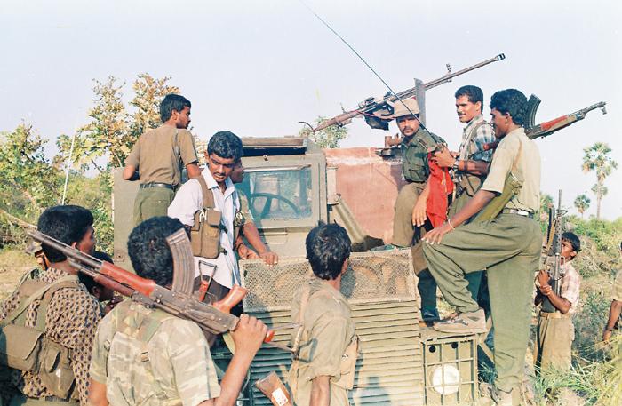 Commander Balraj with his fighters on an Armoured Personnel Carrier seized by the Tigers in Iththaavil.jpg