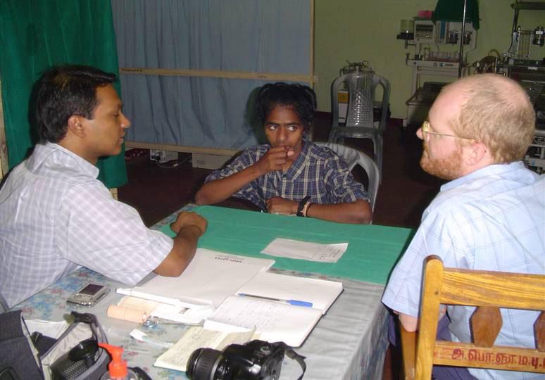 Plastic surgeon from UK, Dr Philip Grey, determining the surgery required to help a female patient..jpg